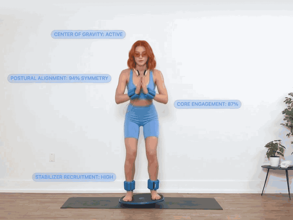A woman balancing on the GoBalance Sport board while the app reads her posture, core engagement and stabiliser recruitment