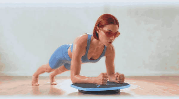 Holding a forearm plank on the board while it tilts underneath